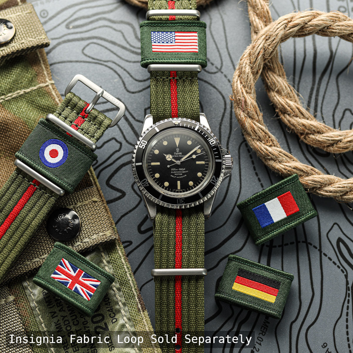 Watch with green fabric strap featuring various flags on a textured surface