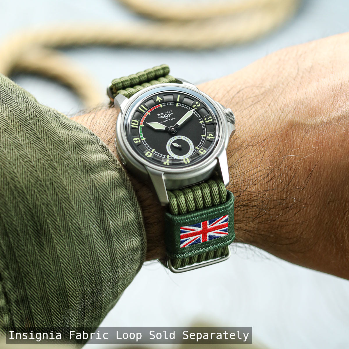 Watch with green strap featuring a Union Jack flag on a wrist, with text about an Insignia fabric loop.