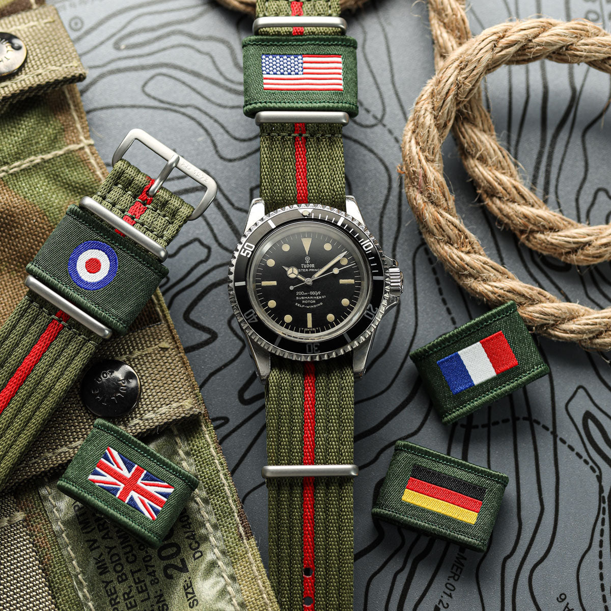 Watch with green strap featuring flags on a textured surface