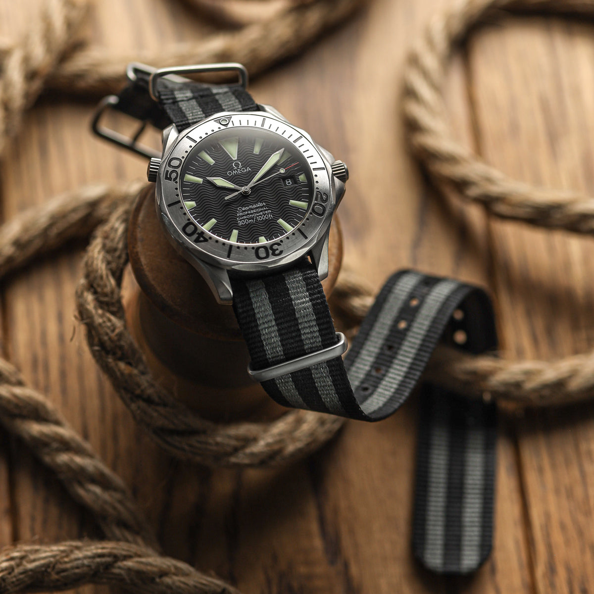 ZULULDIVER classic James Bond NATO watch strap black and grey stripe, satin hardware, white background shot