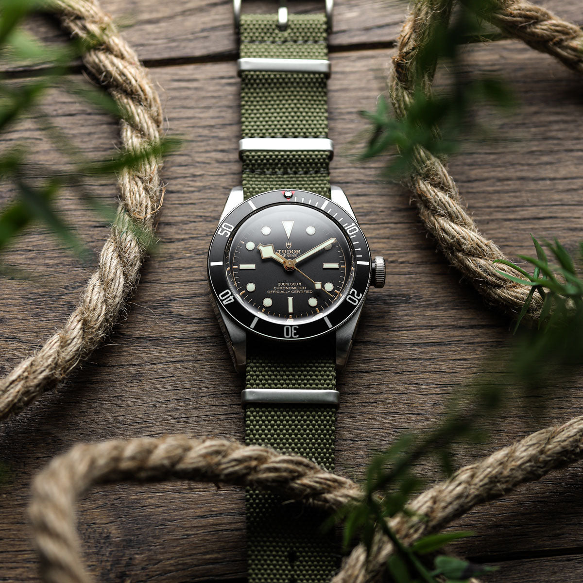 Tudor Black Bay wrist watch fitted to a woven canvas green NATO watch strap