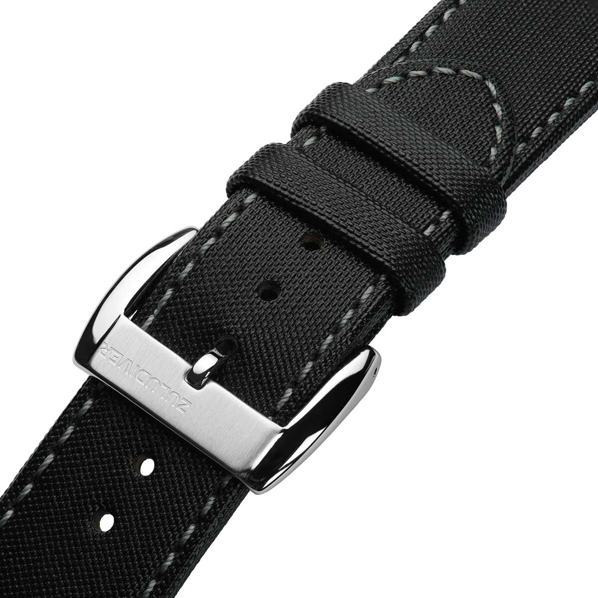 Black sailcloth watch strap with silver buckle on a white background