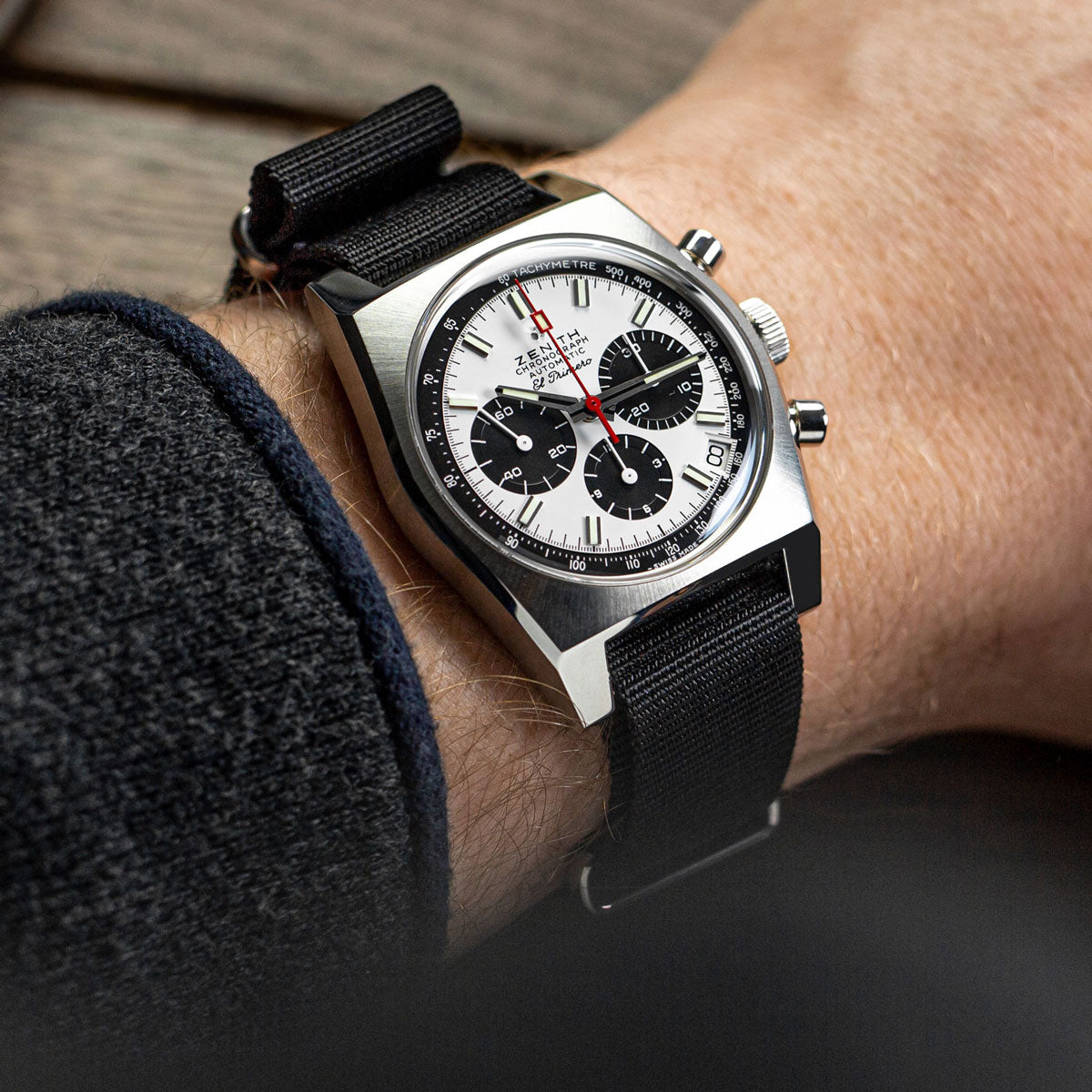 Wrist shot of NATO watch strap, colour black, with stainless steel satin finish hardware, fitted to a Zenith mechanical chronograph watch